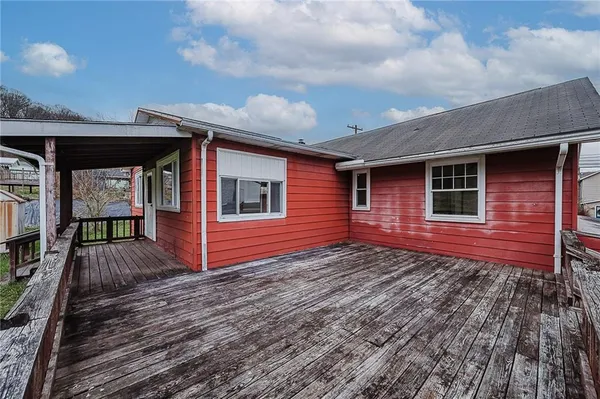 a view of a wooden deck with a yard