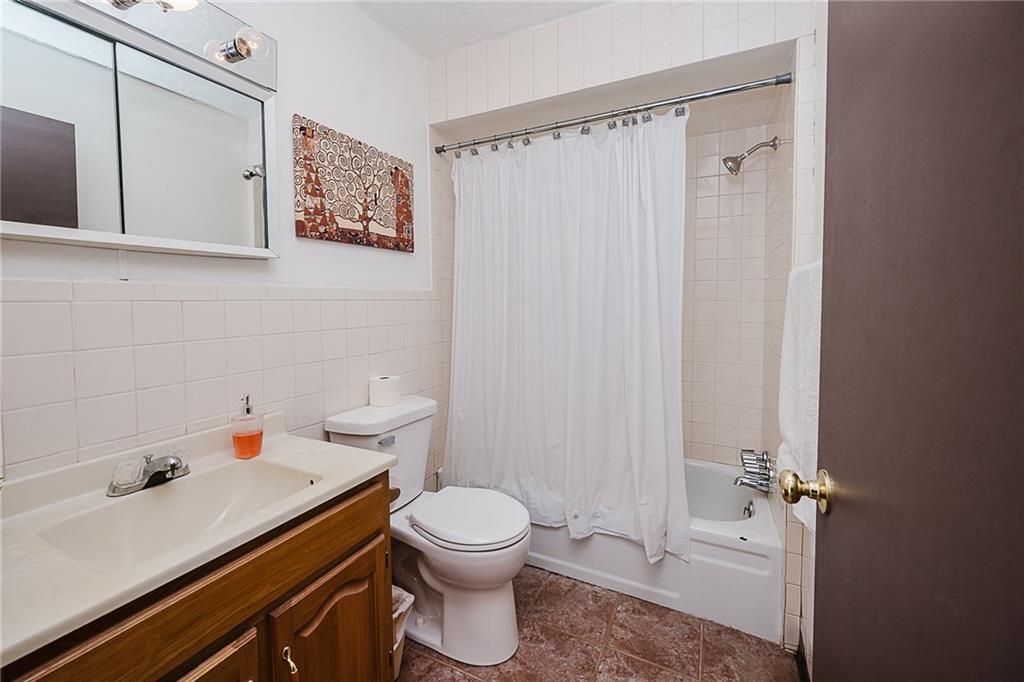 28 Indiana Avenue Avonmore, PA 15618 - Photo 5 of 49 a bathroom with a sink a toilet and shower curtain