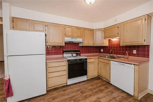 a kitchen with stainless steel appliances a refrigerator and microwave