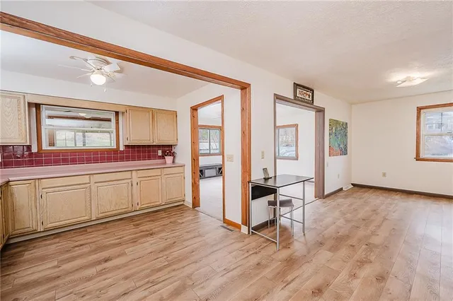 a kitchen with stainless steel appliances a sink cabinets and wooden floor