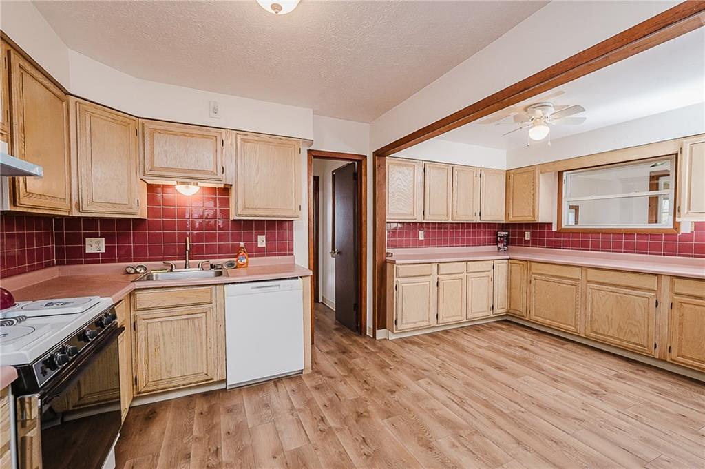28 Indiana Avenue Avonmore, PA 15618 - Photo 10 of 49 a kitchen with stainless steel appliances a sink cabinets and wooden floor