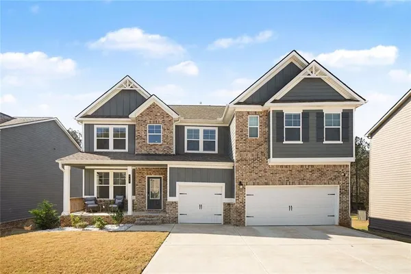a front view of a house with a yard
