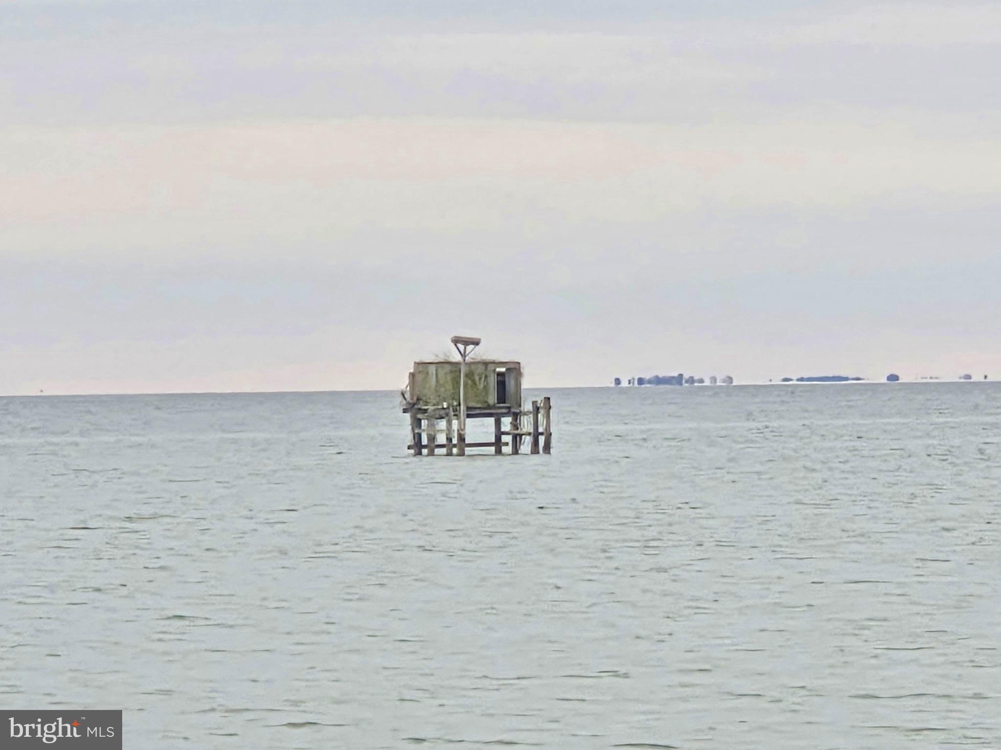 5489 Rude Avenue Tilghman, MD 21671 - Photo 13 of 65 a terrace with a bench and lake view