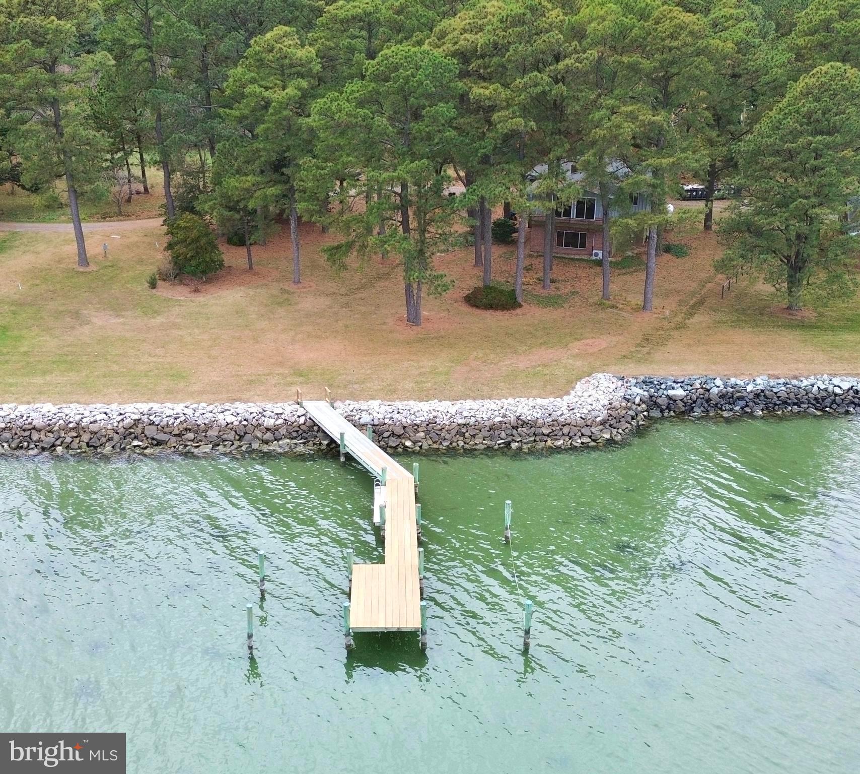 5489 Rude Avenue Tilghman, MD 21671 - Photo 19 of 65 a view of a lake with a yard and large trees