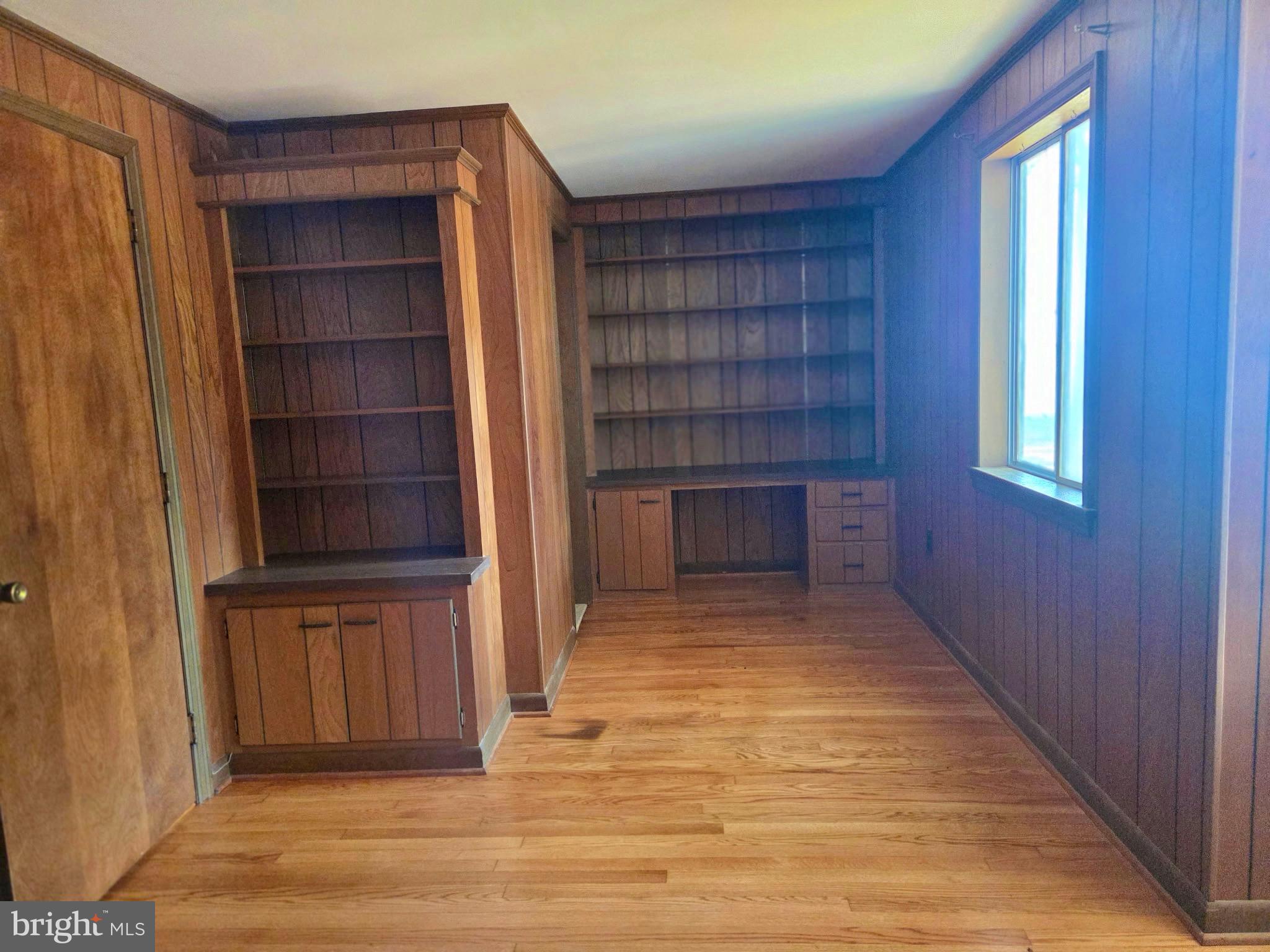5489 Rude Avenue Tilghman, MD 21671 - Photo 23 of 65 a view of empty room with wooden floor and cabinet