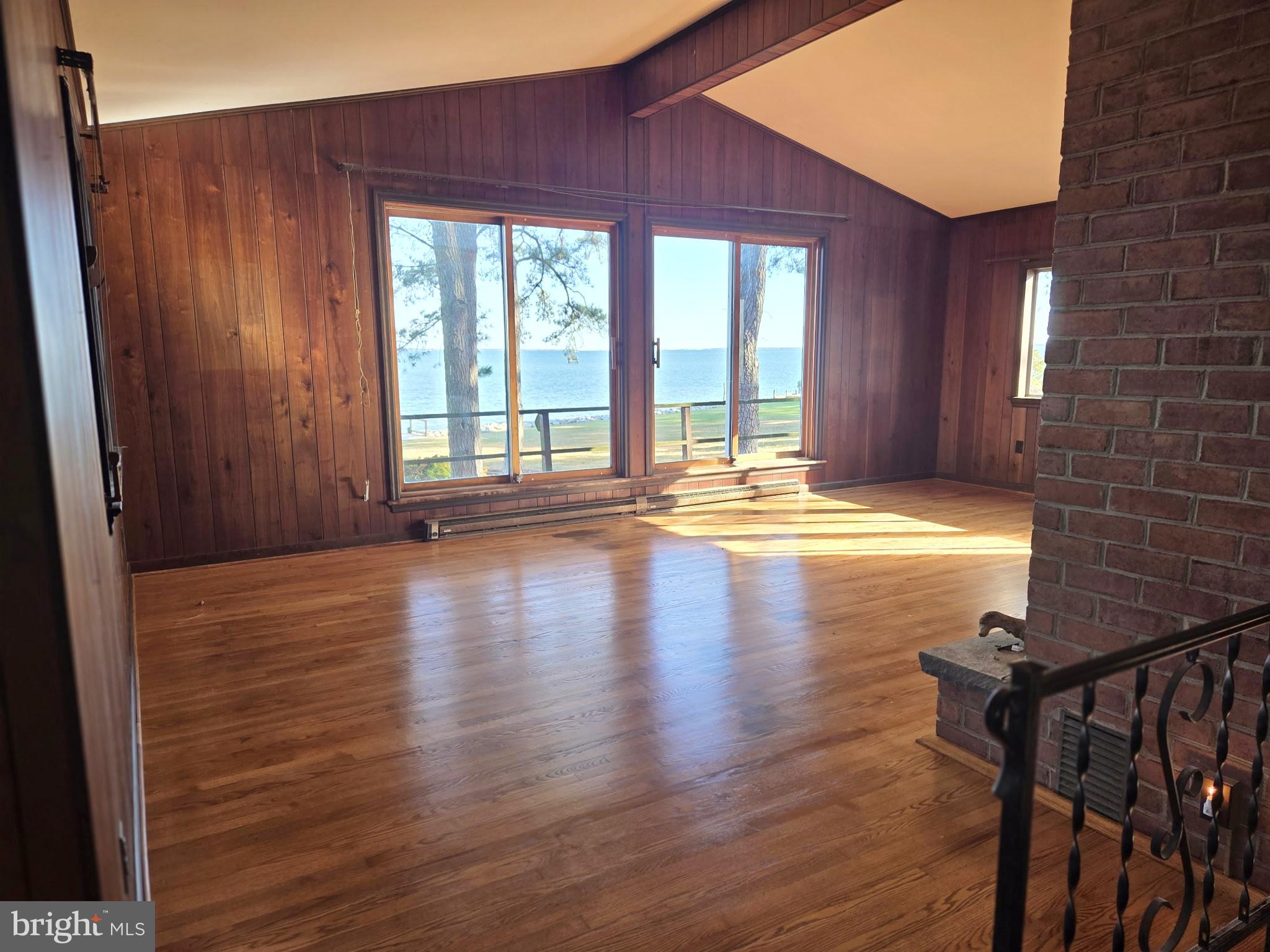 5489 Rude Avenue Tilghman, MD 21671 - Photo 31 of 65 a view of empty room with floor to ceiling window and wooden floor