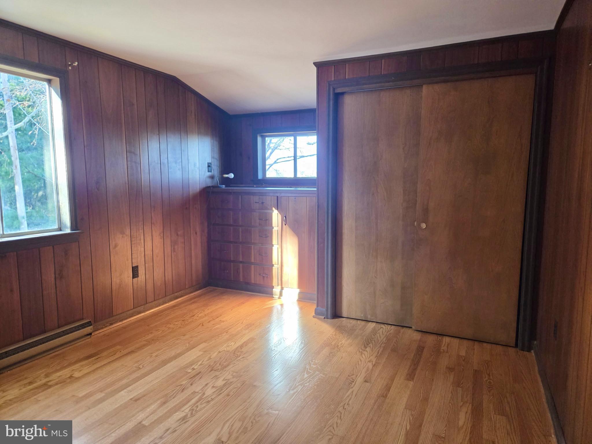 5489 Rude Avenue Tilghman, MD 21671 - Photo 33 of 65 an empty room with wooden floor and windows
