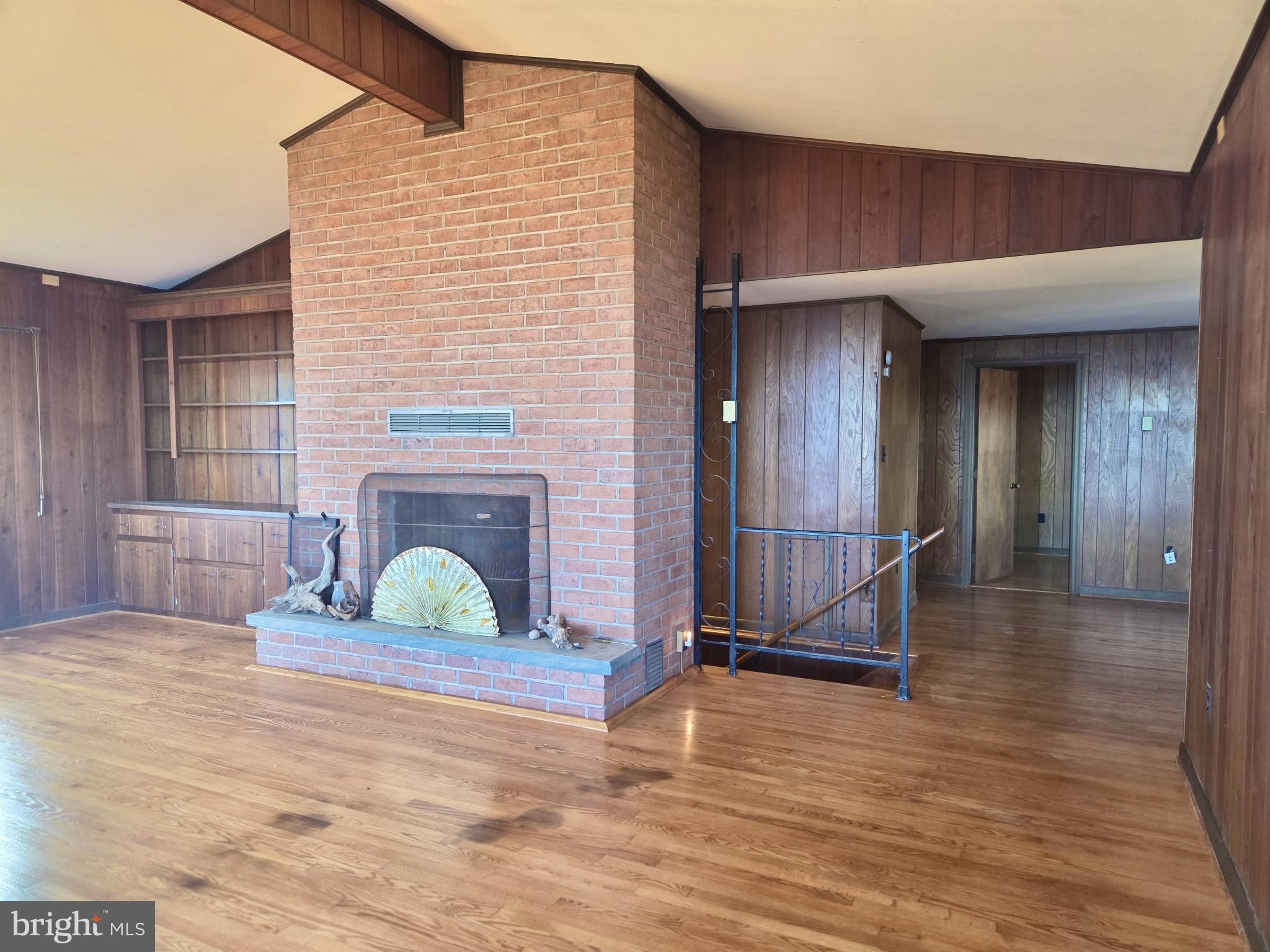 5489 Rude Avenue Tilghman, MD 21671 - Photo 35 of 65 a view of a livingroom with wooden floor and a fireplace
