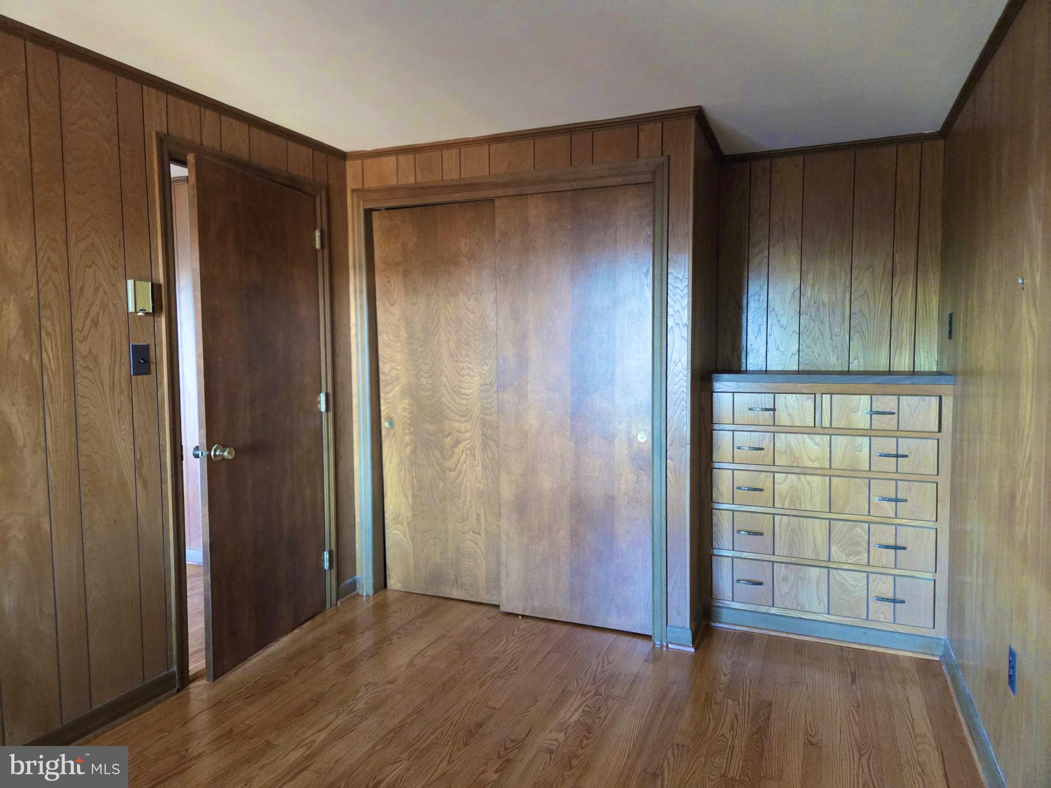 5489 Rude Avenue Tilghman, MD 21671 - Photo 46 of 65 an empty room with wooden floor and windows with curtains