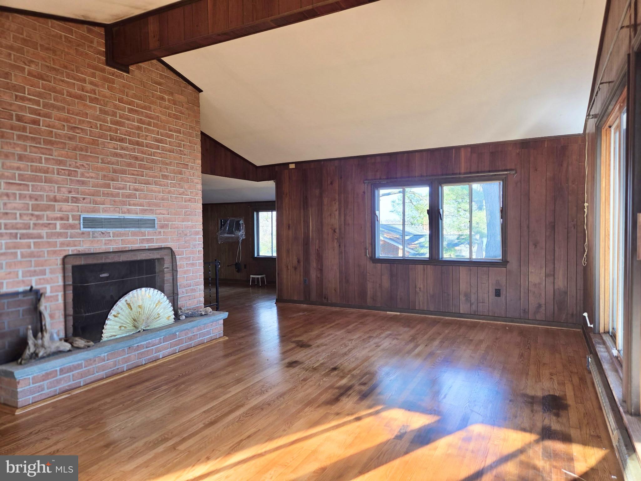 5489 Rude Avenue Tilghman, MD 21671 - Photo 47 of 65 a view of an empty room with wooden floor and a window