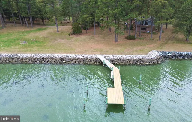 a terrace with a bench and lake view