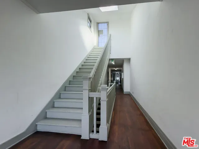 a view of entryway and hall with wooden floor