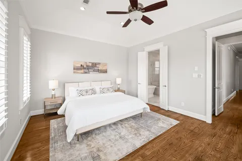 a bedroom with a large bed and a chandelier