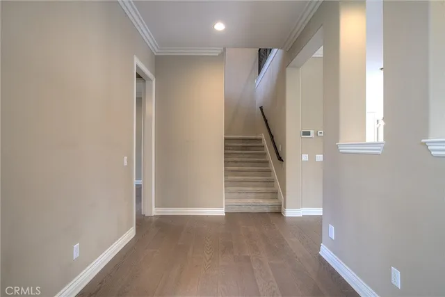 a view of a kitchen with wooden floor and white doors