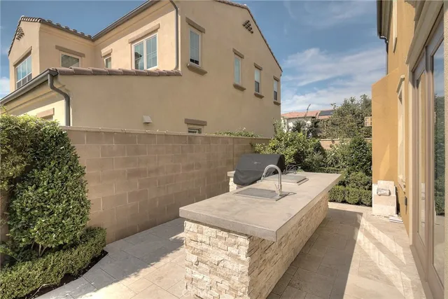a view of a patio with a table chairs and a umbrella