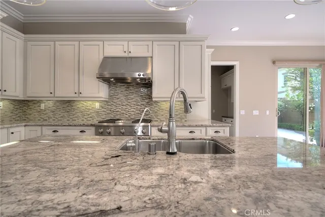 a kitchen with stainless steel appliances a sink stove and cabinets