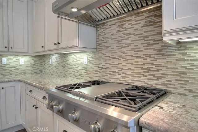 a stove top oven sitting inside of a kitchen