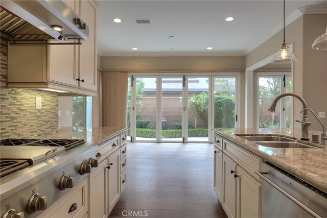 a kitchen with granite countertop a sink and a stove