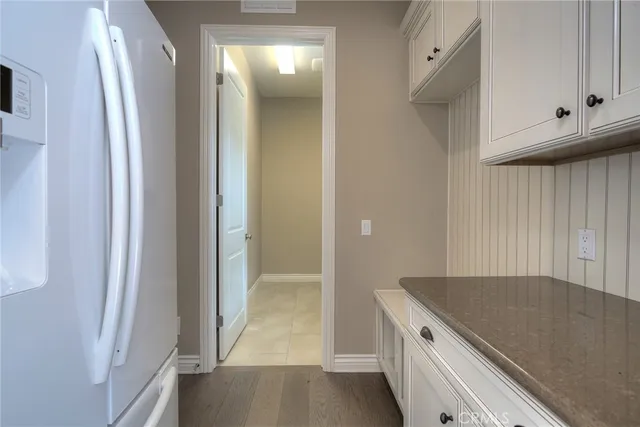 a view of a room with wooden floor and windows