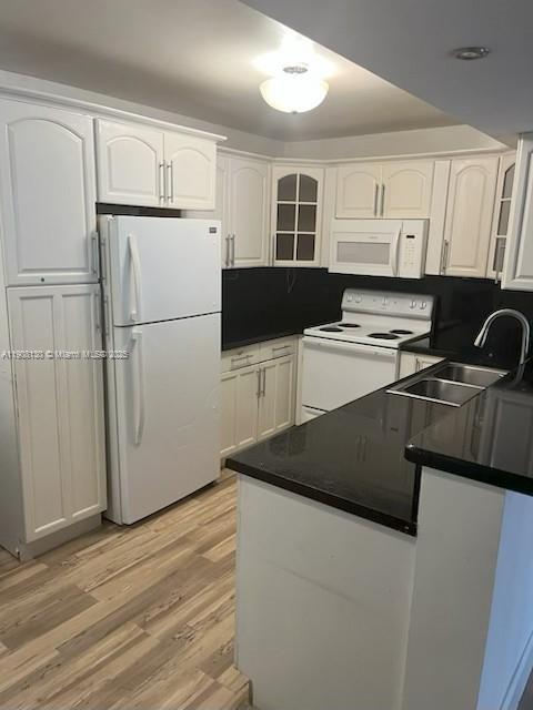 5530 Northwest 61st Street, Unit 304 Coconut Creek, FL 33073 - Photo 1 of 2 a kitchen with stainless steel appliances a refrigerator stove microwave and sink