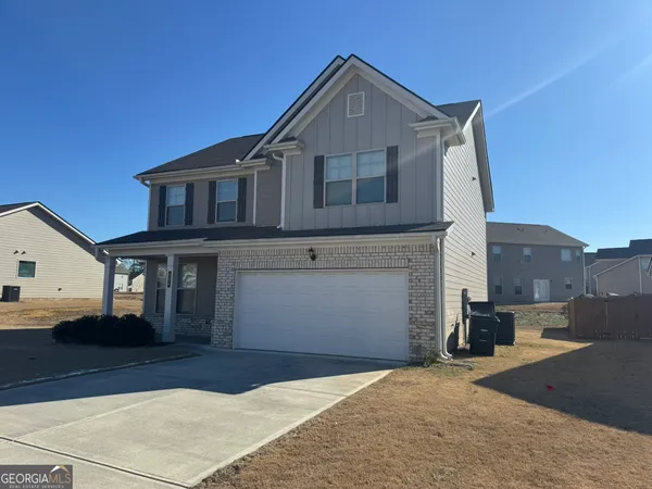 a front view of a house with a yard