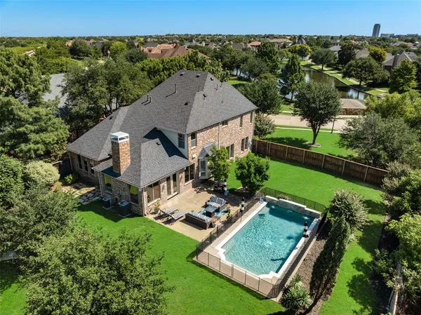 an aerial view of a house with backyard