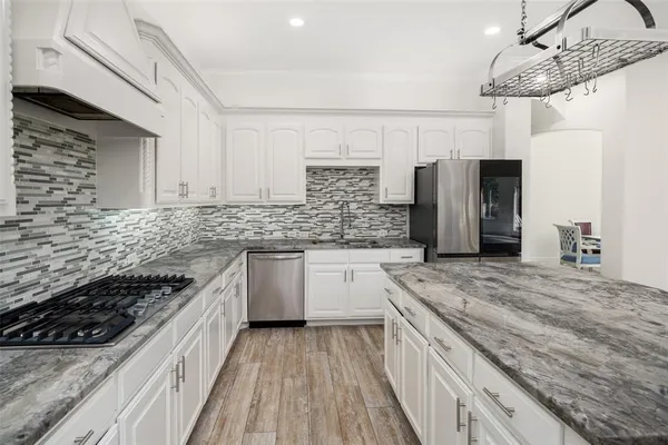 a kitchen with stainless steel appliances granite countertop a stove and a sink