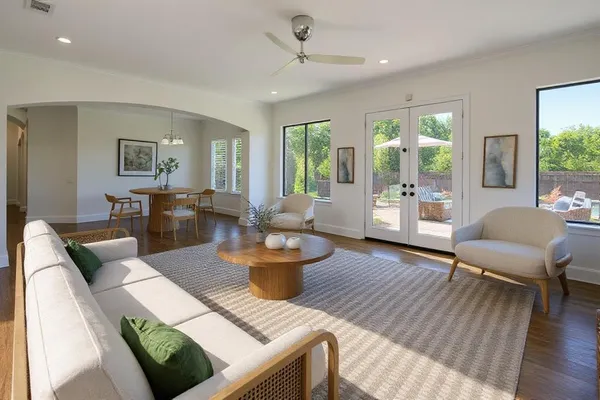 a living room with furniture and a wooden floor