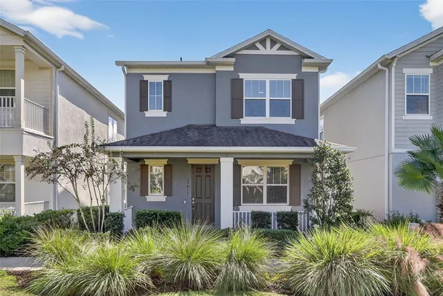 a view of a house with a small yard plants and palm trees