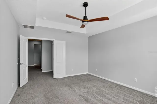 a view of a room with a ceiling fan