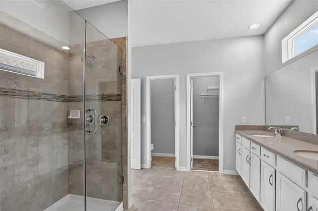 a bathroom with a granite countertop shower mirror and a sink