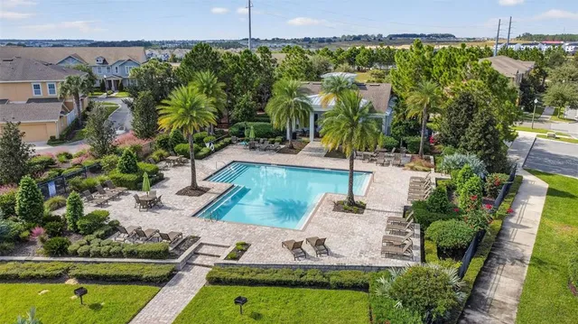 an aerial view of a house with yard swimming pool and outdoor seating