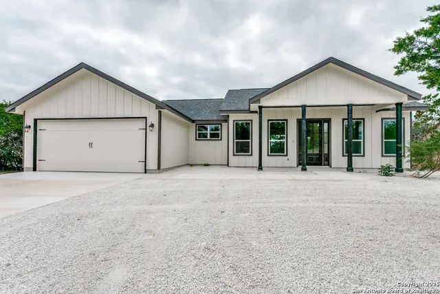 front view of a house with a yard and garage
