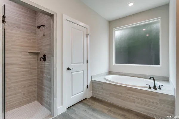 a bathroom with a bathtub and a shower