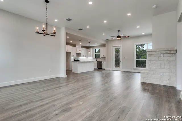 a view of a kitchen with stove and wooden floor
