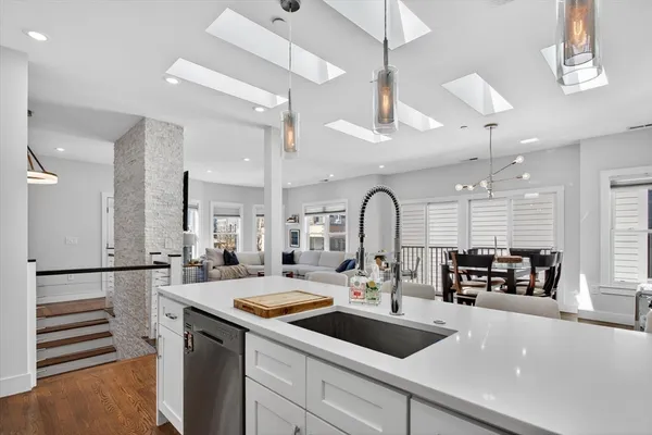 a kitchen with sink a counter and cabinets