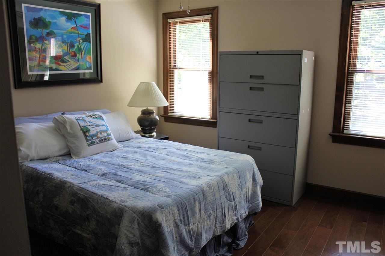 9504 Springdale Drive Raleigh, NC 27613 - Photo 15 of 25 a bedroom with a bed and a window