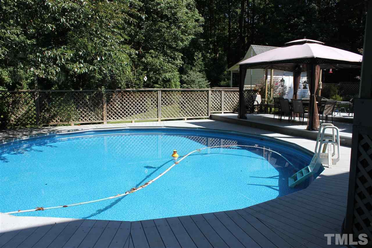 9504 Springdale Drive Raleigh, NC 27613 - Photo 19 of 25 a view of a swimming pool with deck and patio