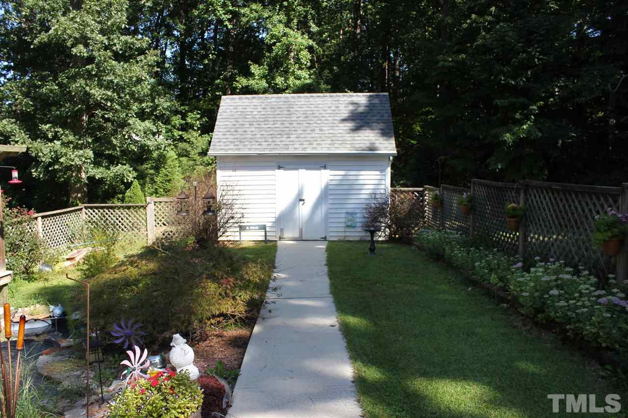 9504 Springdale Drive Raleigh, NC 27613 - Photo 23 of 25 a view of a pathway of a house