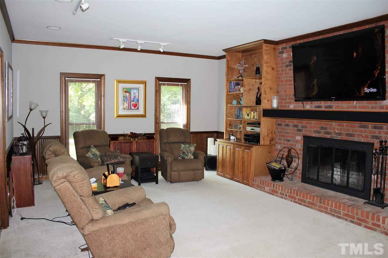 9504 Springdale Drive Raleigh, NC 27613 - Photo 3 of 25 a living room with furniture and a fireplace