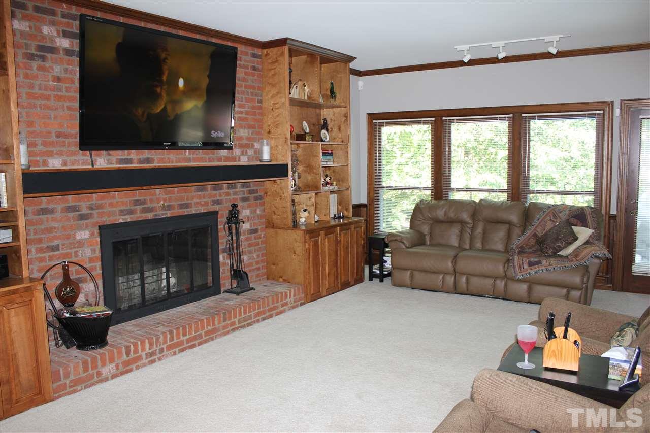 9504 Springdale Drive Raleigh, NC 27613 - Photo 4 of 25 a living room with furniture and a fireplace