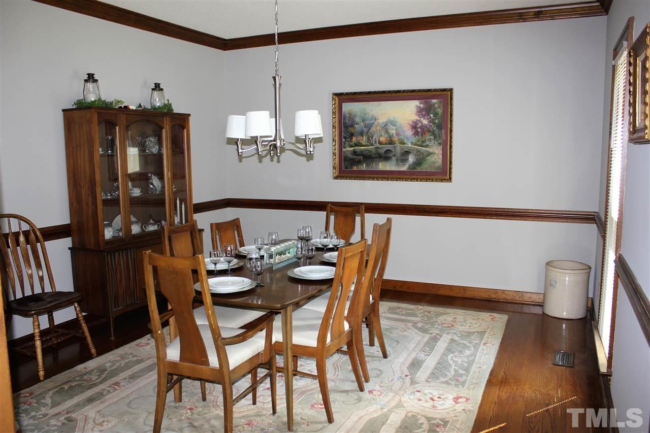 9504 Springdale Drive Raleigh, NC 27613 - Photo 5 of 25 a view of a dining room with furniture and chandelier