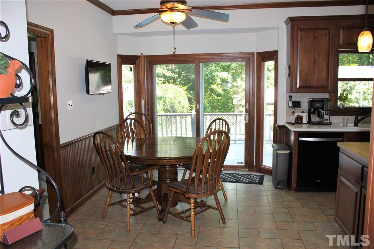 9504 Springdale Drive Raleigh, NC 27613 - Photo 6 of 25 a dining room with furniture a chandelier and window