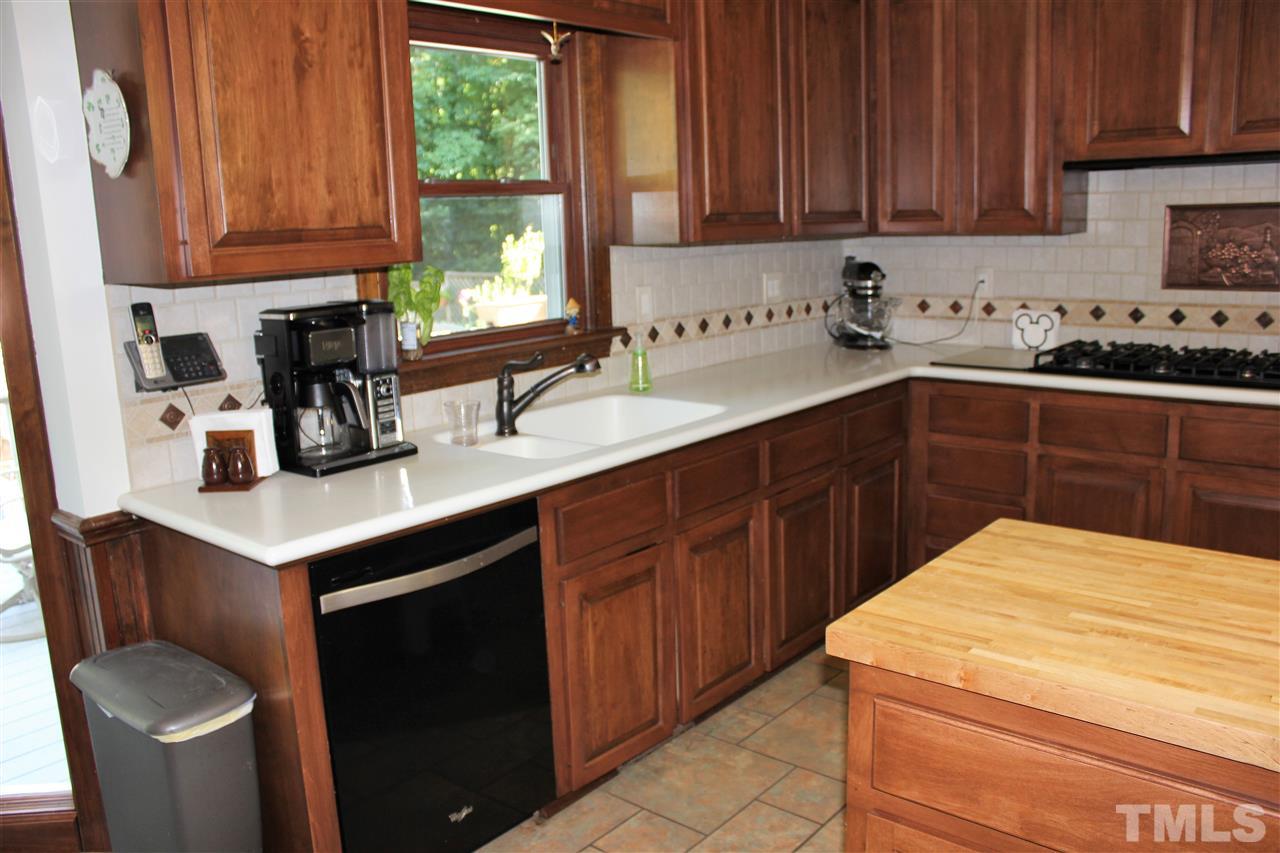 9504 Springdale Drive Raleigh, NC 27613 - Photo 8 of 25 a kitchen with a sink cabinets and window
