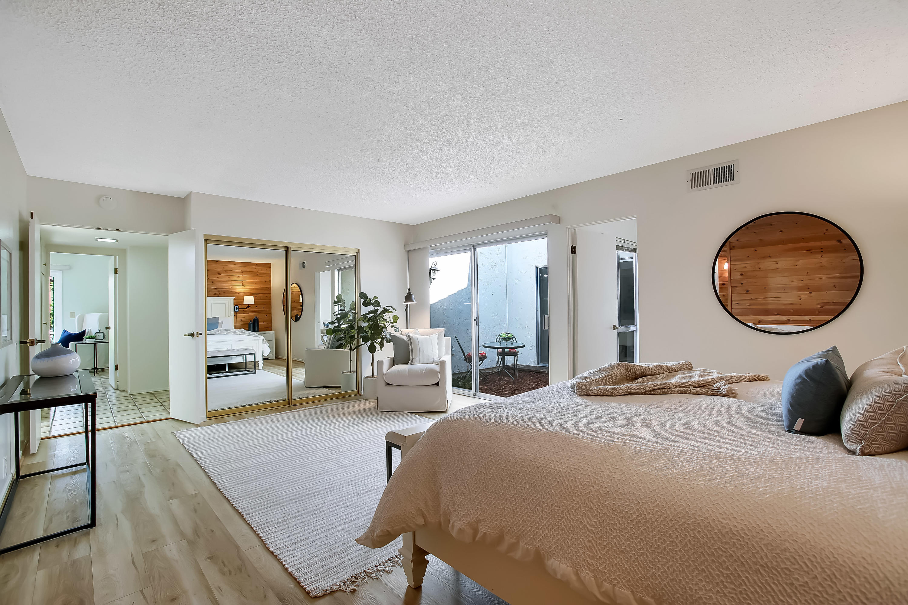 7206 Georgetown Road Goleta, CA 93117 - Photo 12 of 34 a bedroom with a large bed and a large mirror