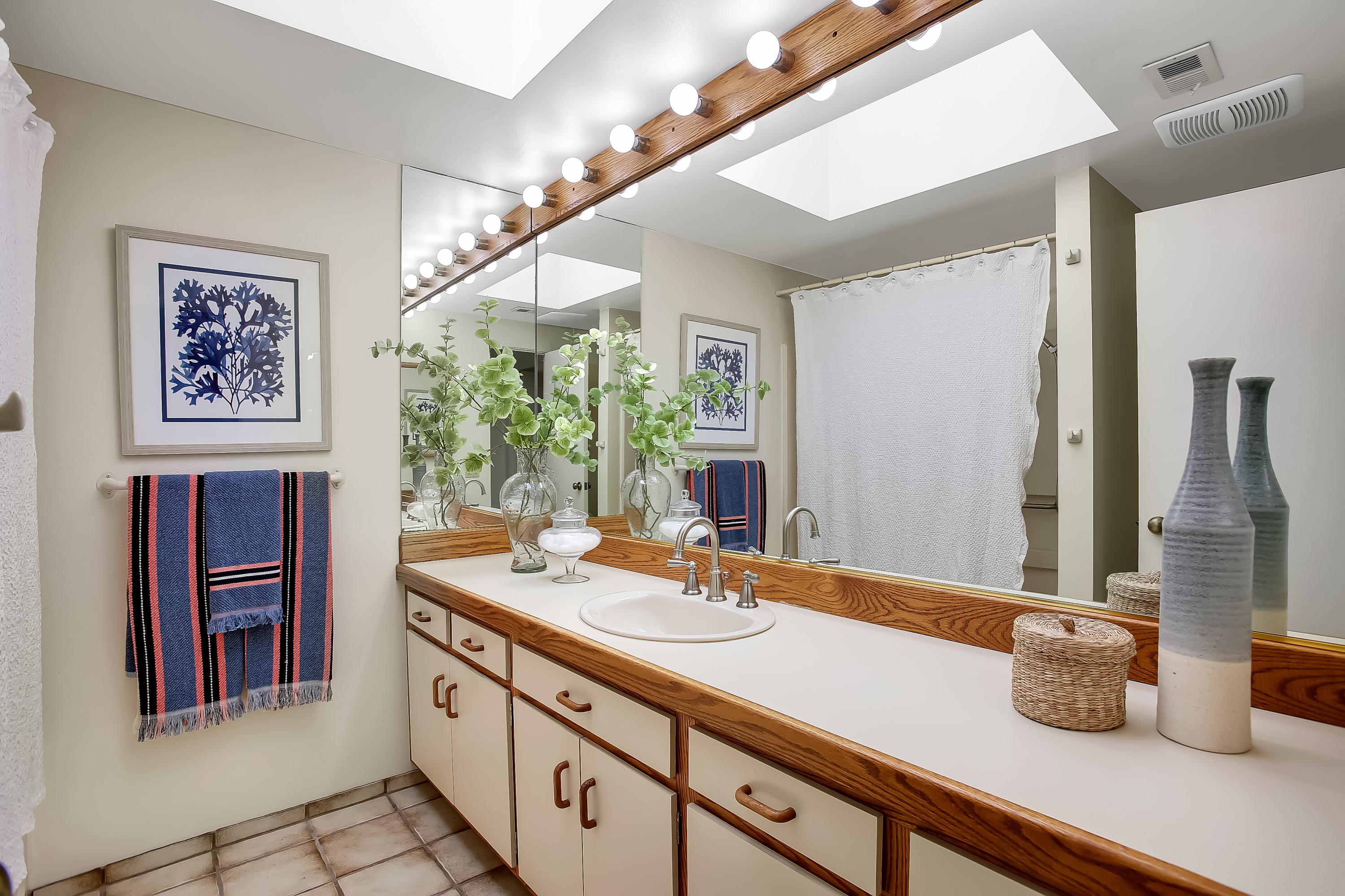 7206 Georgetown Road Goleta, CA 93117 - Photo 18 of 34 a bathroom with a sink a large mirror and a shower