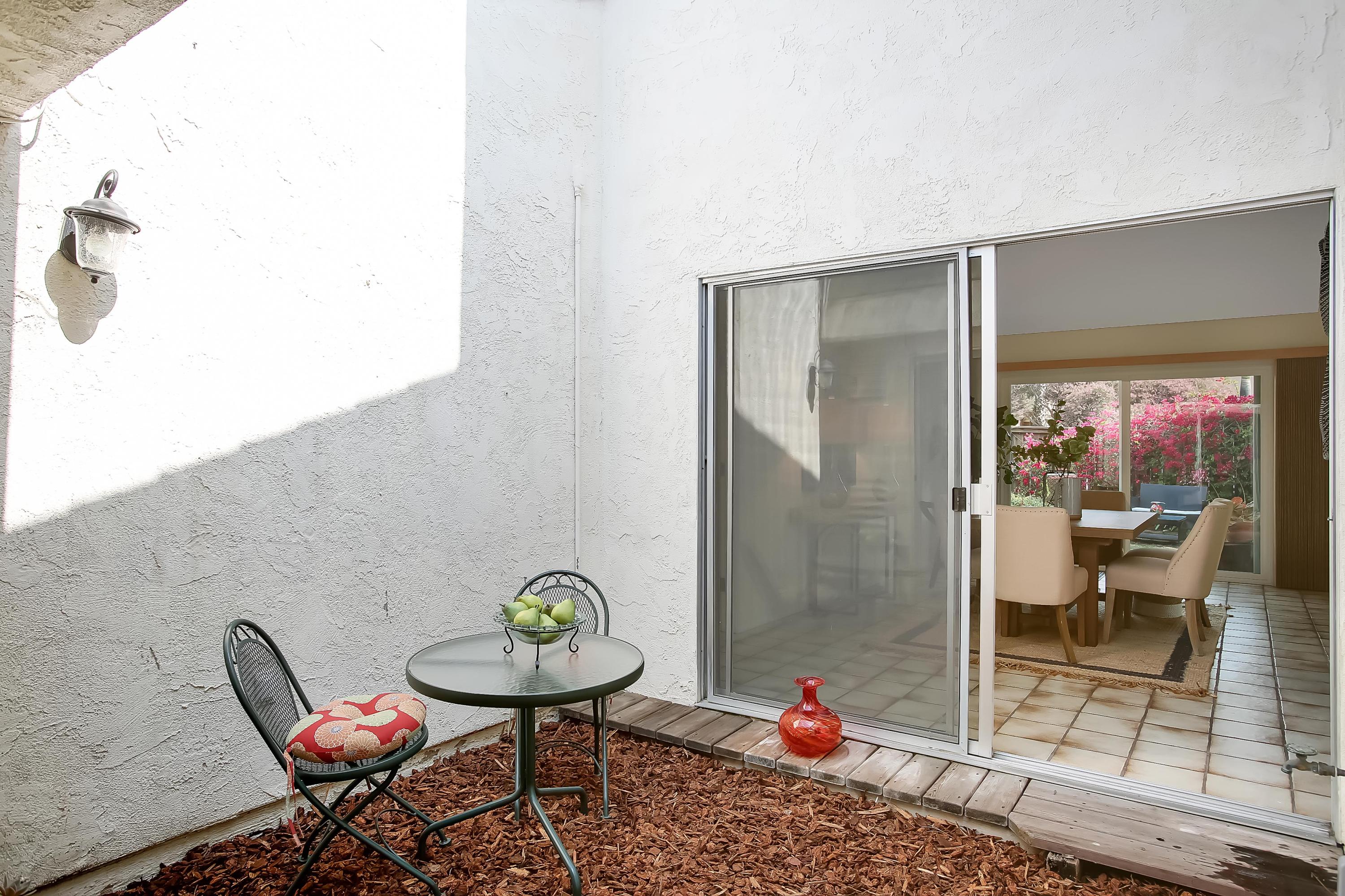 7206 Georgetown Road Goleta, CA 93117 - Photo 21 of 34 a balcony with a table and chairs
