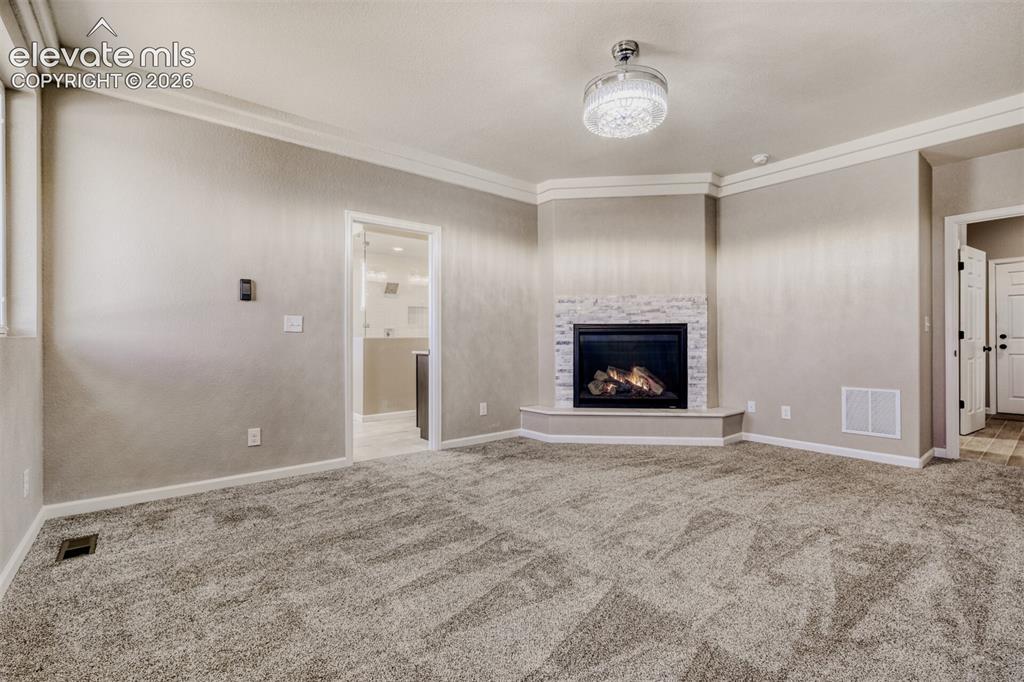 13680 Woodlake Road Elbert, CO 80106 - Photo 21 of 46 Primary Bedroom with fireplace, massive closet, lux 5-piece bath