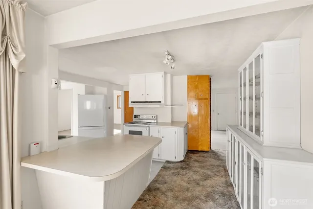 a view of a kitchen cabinets and wooden floor