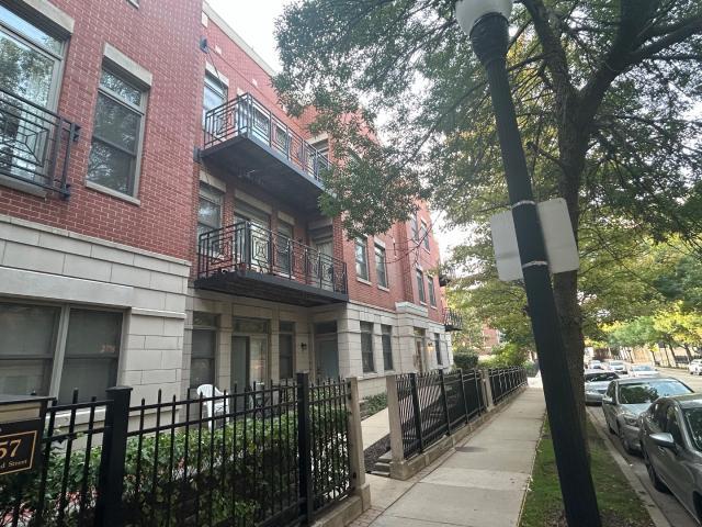 1461 South Halsted Street, Unit 1B Chicago, IL 60607 - Photo 1 of 20 a front view of a house with a garden